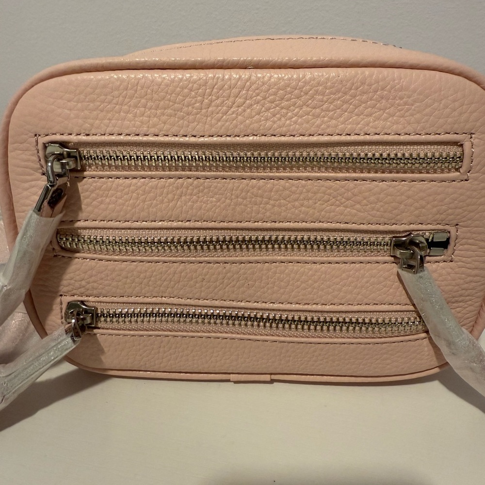 Stylish Pink Crossbody Bag with Textured Leather and Multiple Zippers
